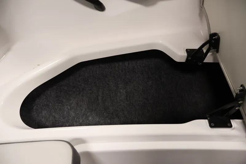 Slide: The Image of 2021 Yamaha AR190 boat storage compartment with black carpet lining. - 15