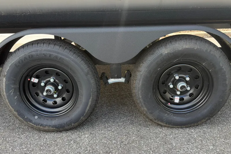 Slide: The Image of Dual black wheels on a 2027 Sun Tracker Party Barge 22 RF DLX trailer. - 13