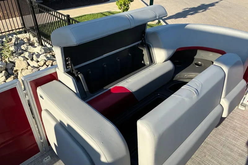 Slide: The Image of 2027 Sun Tracker Party Barge 22 RF DLX interior seating with storage compartments open. - 18