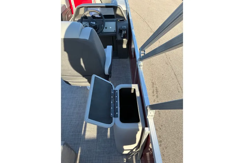 Slide: The Image of Interior view of 2027 Sun Tracker Party Barge 22 RF DLX with open storage compartment. - 15
