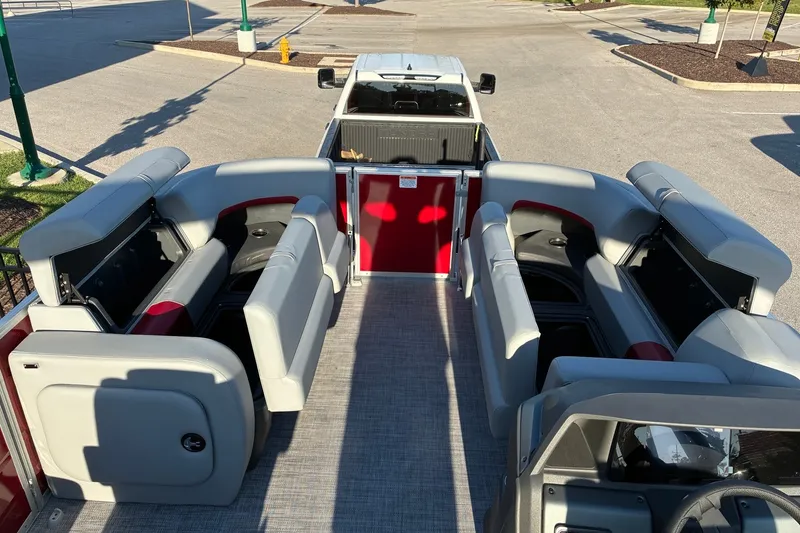 Slide: The Image of 2027 Sun Tracker Party Barge 22 RF DLX interior with plush seating and open layout. - 17