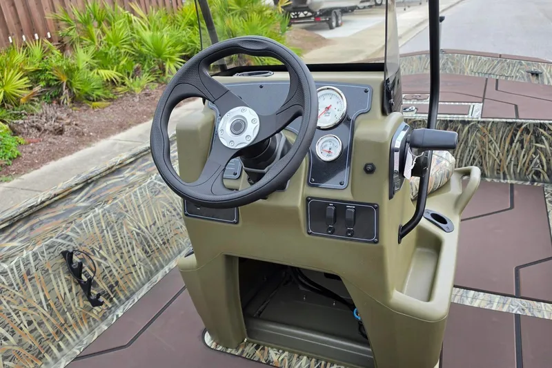 Slide: The Image of Steering console of 2027 Tracker Grizzly 1860 CC boat with camo design. - 14