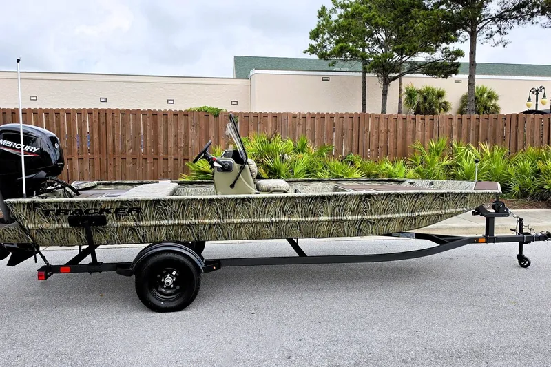 The Image of 2027 Tracker Grizzly 1860 CC boat on trailer, camo design, parked outdoors. - 0