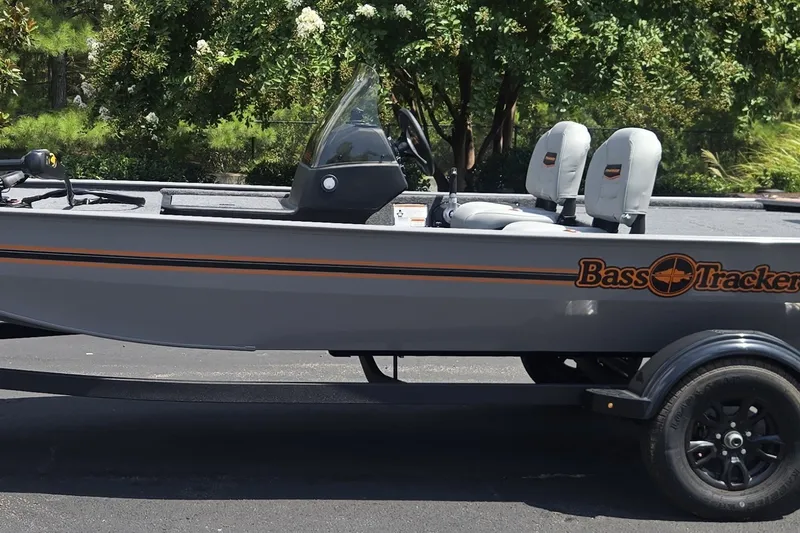 The Image of 2027 Tracker Bass Tracker Classic Limited boat on trailer, parked outdoors. - 0