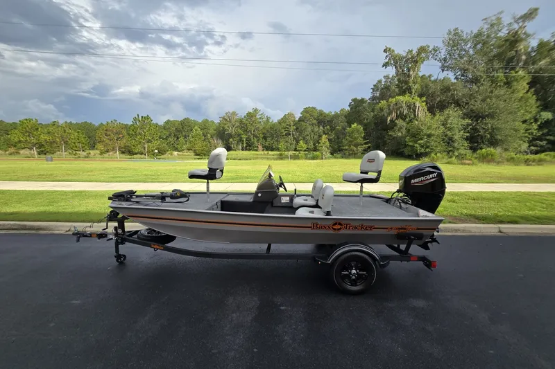 The Image of 2027 Tracker Bass Tracker Classic Limited boat on trailer, parked outdoors. - 0