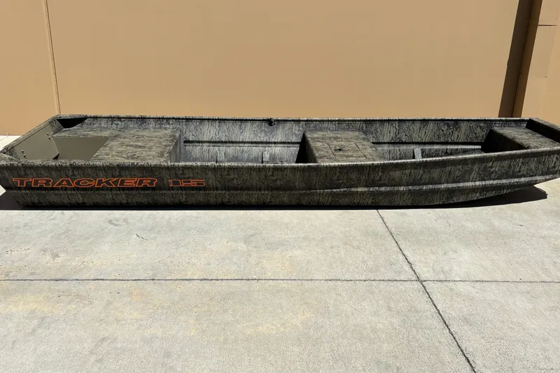 The Image of 2027 Tracker Grizzly 15 Jon boat on concrete surface, showcasing rugged design. - 0