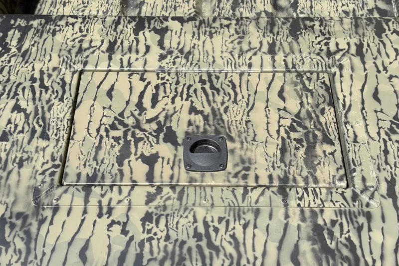 Slide: The Image of Camouflage-patterned Tracker Grizzly 15 Jon boat deck, 2027 model, with hatch detail. - 17