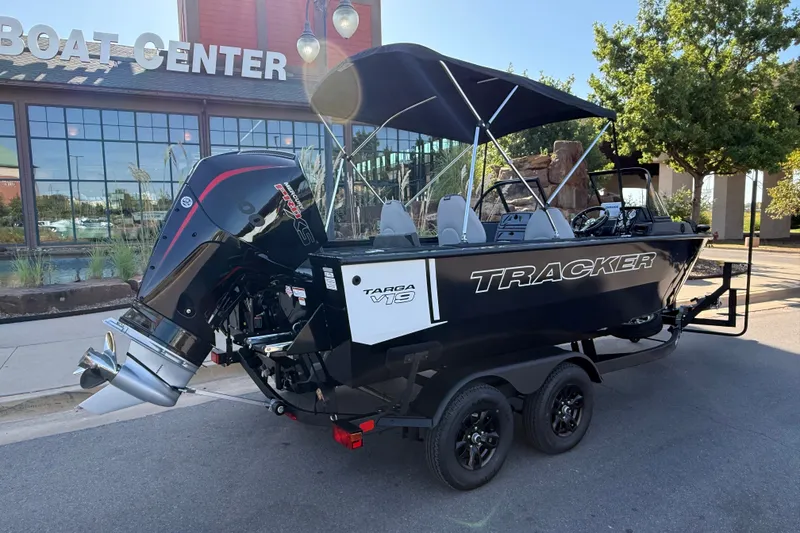 Slide: The Image of 2027 Tracker Targa V-19 Combo boat parked outside a boat center, showcasing its sleek design. - 14