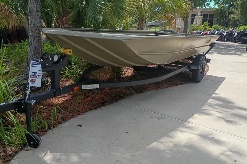 The Image of 2027 Tracker Grizzly 1754 Utility boat on trailer, parked outdoors. - 0