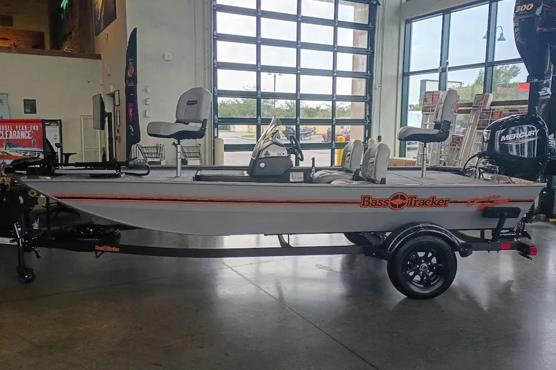 Slide: The Image of 2027 Tracker Bass Tracker Classic Limited boat displayed indoors on a trailer. - 24