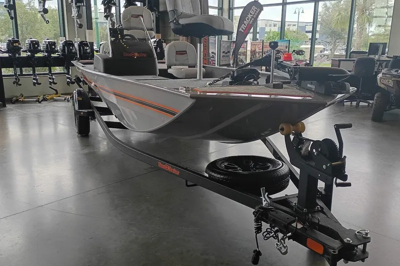The Image of 2027 Tracker Bass Tracker Classic Limited boat displayed in showroom with trailer. - 0