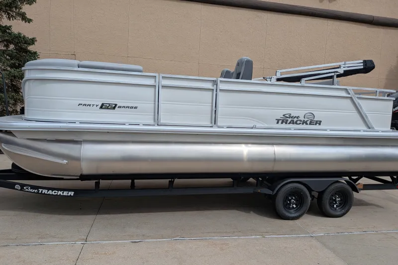 The Image of 2027 Sun Tracker Party Barge 22 RF DLX pontoon boat on trailer. - 0