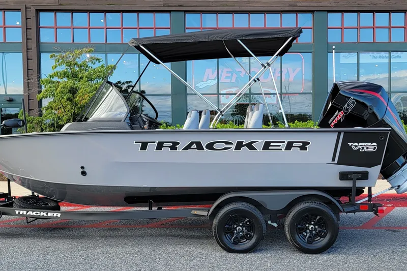 The Image of 2027 Tracker Targa V-19 Combo boat on trailer, parked outside a building. - 0