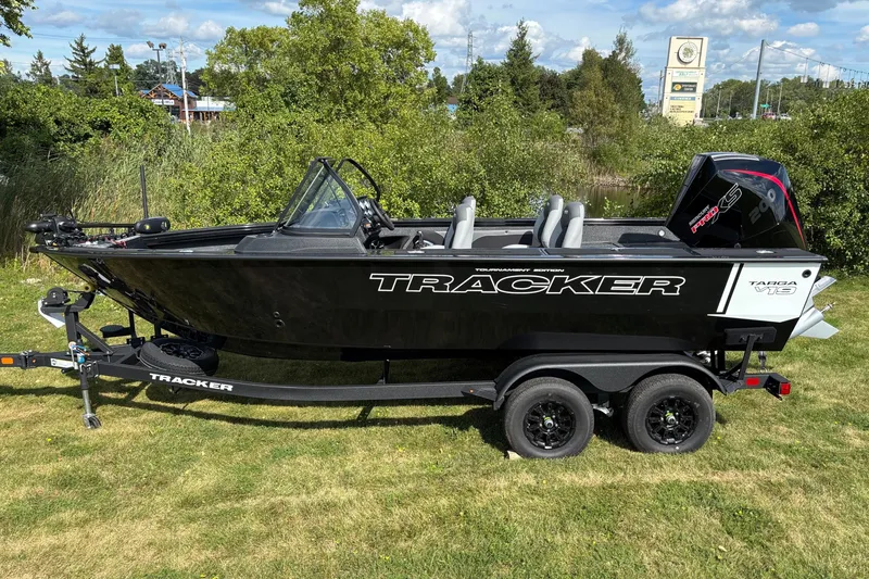 The Image of 2027 Tracker Targa V-19 Combo boat on trailer, parked on grass. - 0