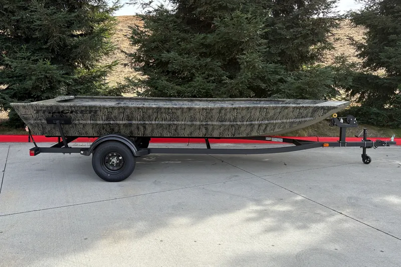 The Image of 2027 Tracker Grizzly 1754 Utility boat on trailer, parked outdoors. - 0