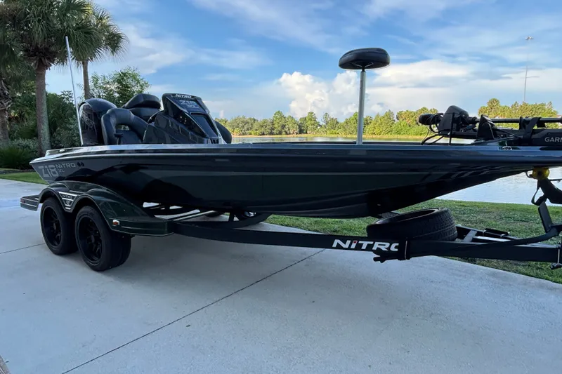 The Image of 2027 Nitro Z18 XL Pro fishing boat on trailer by a lakeside. - 0