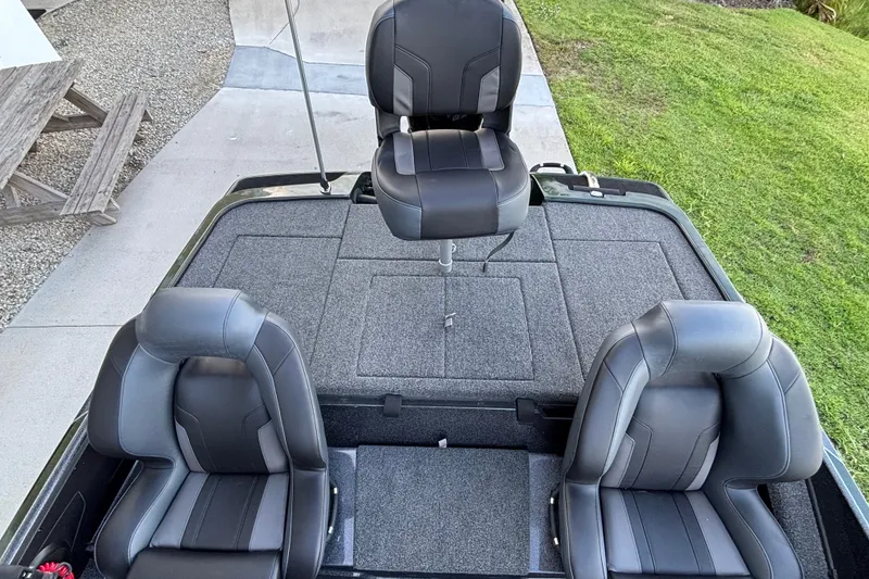 Slide: The Image of 2027 Nitro Z18 XL Pro boat interior with three black seats on a gray deck. - 7