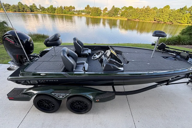 Slide: The Image of 2027 Nitro Z18 XL Pro fishing boat by a scenic lake. - 6