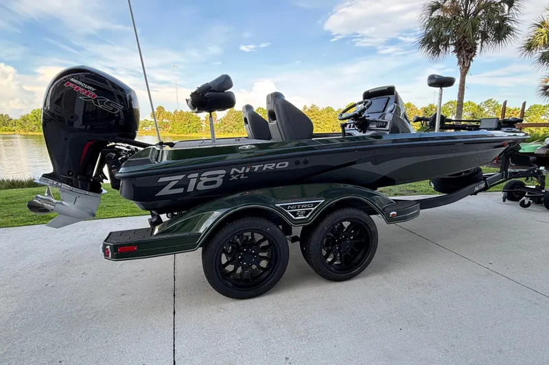 Slide: The Image of 2027 Nitro Z18 XL Pro boat on trailer by lakeside, featuring sleek design and powerful engine. - 1