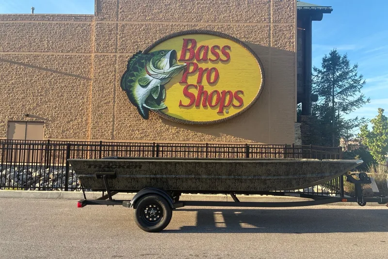 The Image of 2027 Tracker Grizzly 1754 Utility boat on trailer outside Bass Pro Shops. - 0