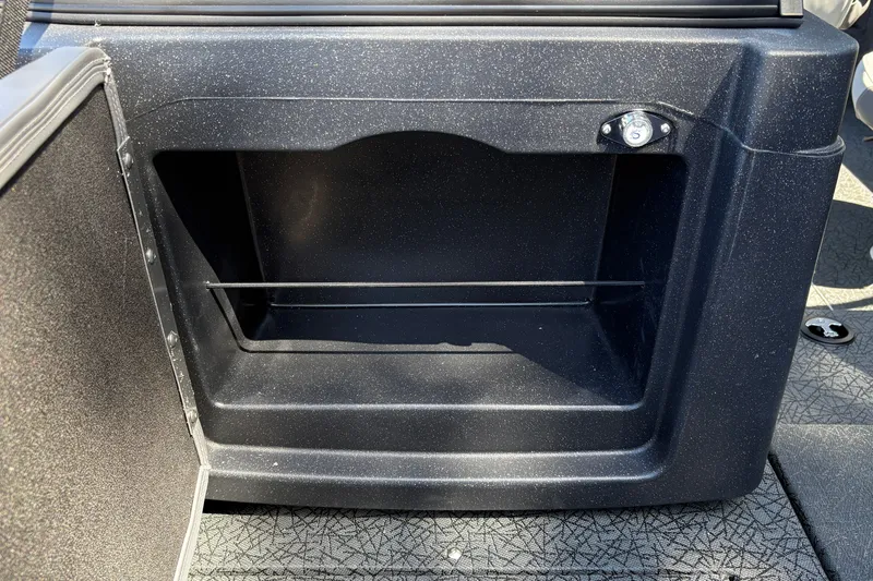 Slide: The Image of Storage compartment in 2027 Tracker Targa V-19 Combo boat, featuring a sleek black interior. - 18