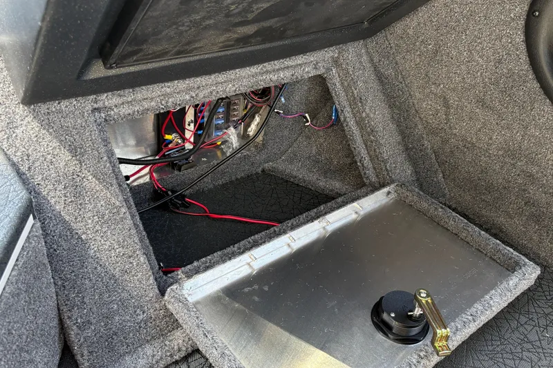 Slide: The Image of Interior view of 2027 Tracker Targa V-19 Combo boat showing wiring and storage compartment. - 25