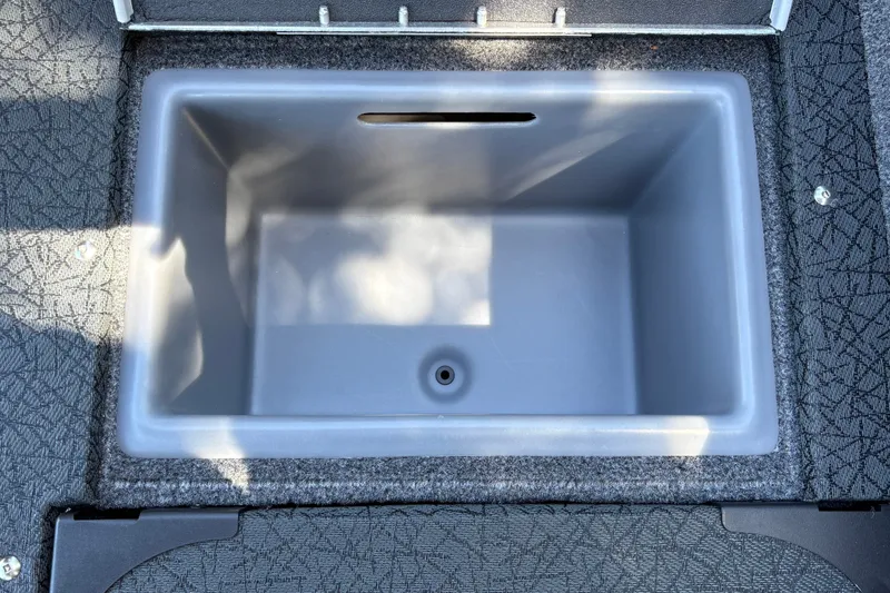 Slide: The Image of 2027 Tracker Targa V-19 Combo boat storage compartment, empty and open. - 17