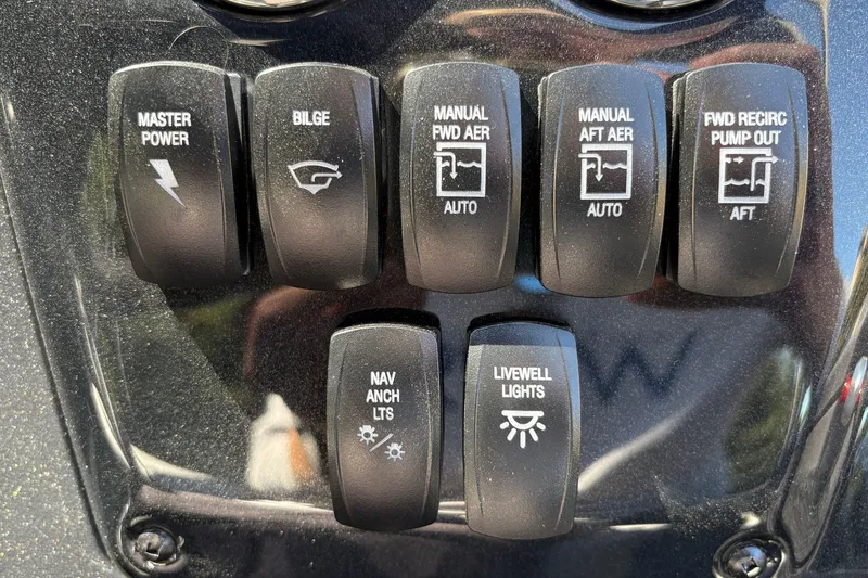 Slide: The Image of Control panel of 2027 Tracker Targa V-19 Combo boat with various switches. - 13