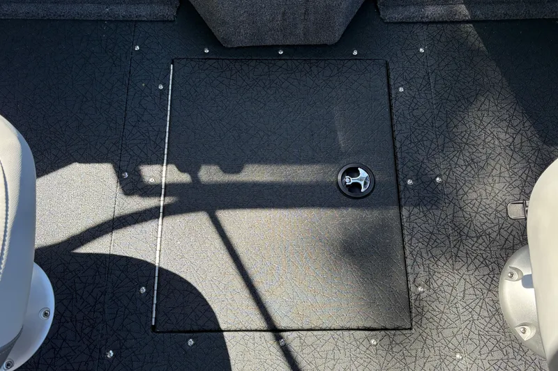 Slide: The Image of Floor hatch on 2027 Tracker Targa V-19 Combo boat, featuring textured surface and latch. - 26