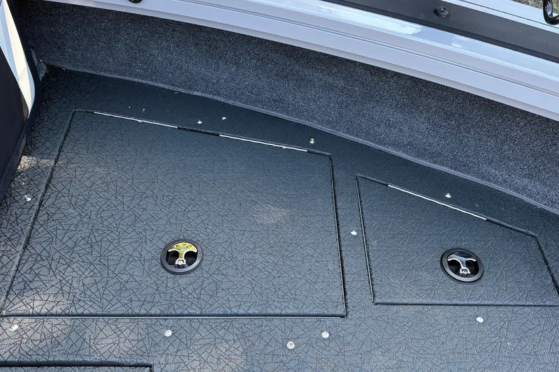 Slide: The Image of 2027 Tracker Targa V-19 Combo boat deck with storage compartments. - 24