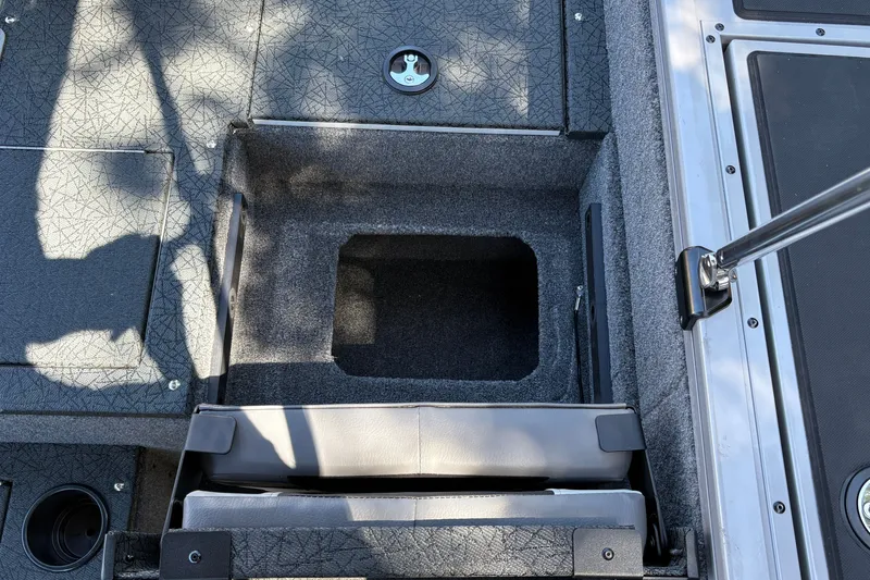 Slide: The Image of 2027 Tracker Targa V-19 Combo boat interior storage compartment with textured flooring. - 15