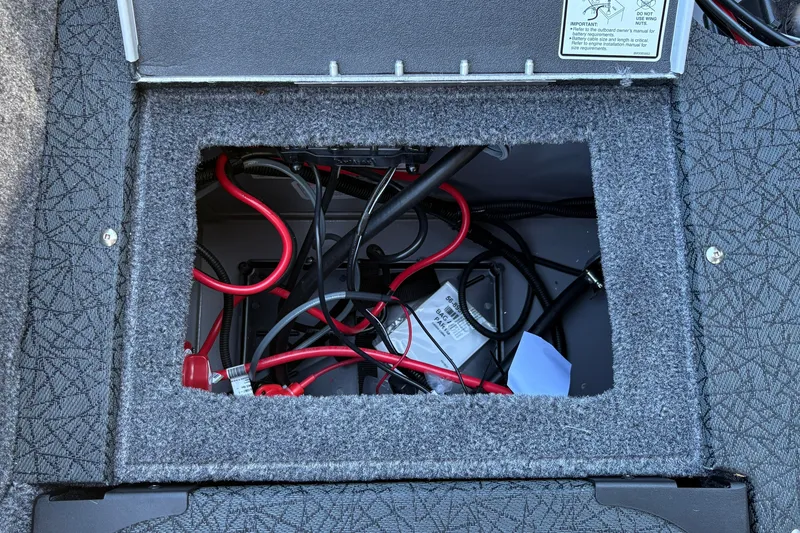 Slide: The Image of Open compartment with wiring inside a 2027 Tracker Targa V-19 Combo boat. - 27