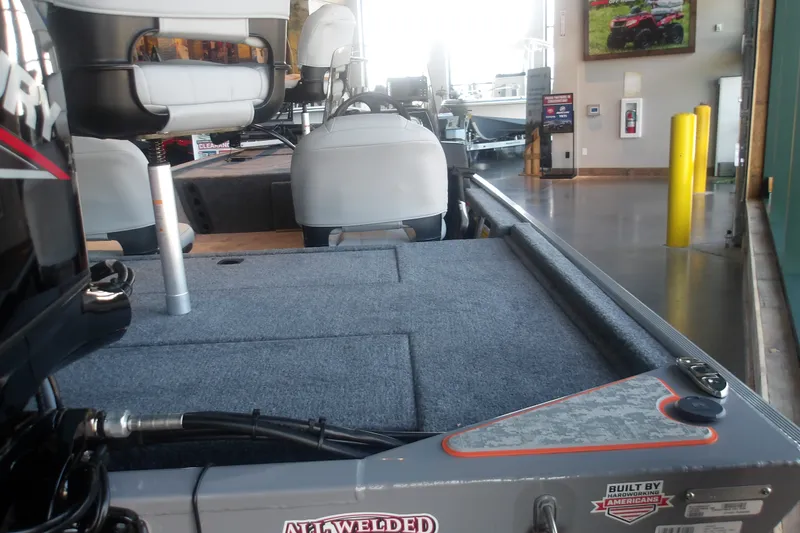 Slide: The Image of 2027 Tracker Bass Tracker Classic Limited boat interior with seating and carpeted deck. - 15