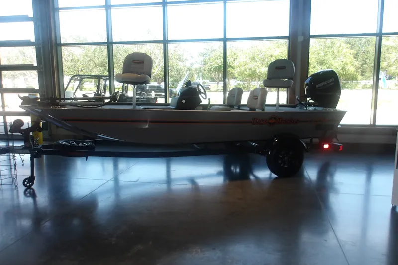 The Image of 2027 Tracker Bass Tracker Classic Limited boat displayed indoors with trailer. - 2