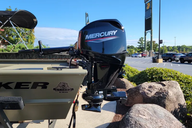 The Image of 2027 Tracker Grizzly 1754 Utility boat with Mercury outboard motor in parking lot. - 0