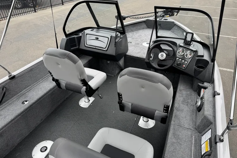 Slide: The Image of 2027 Tracker Pro Guide V-16 WT boat interior with steering console and seating. - 13