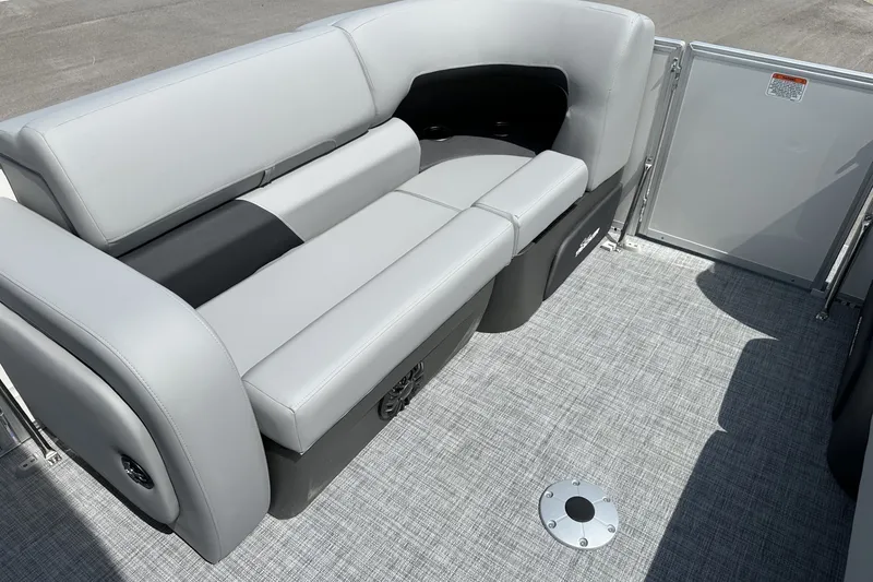Slide: The Image of 2027 Sun Tracker Party Barge 22 RF DLX interior with gray seating and textured flooring. - 14