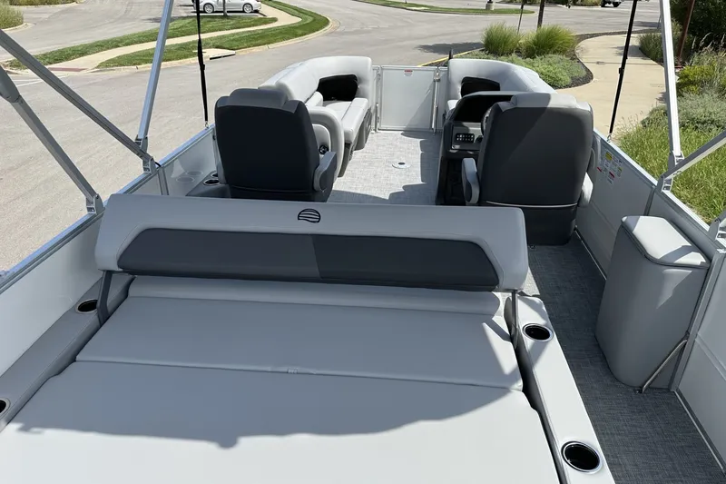 Slide: The Image of 2027 Sun Tracker Party Barge 22 RF DLX interior with seating and helm. - 23