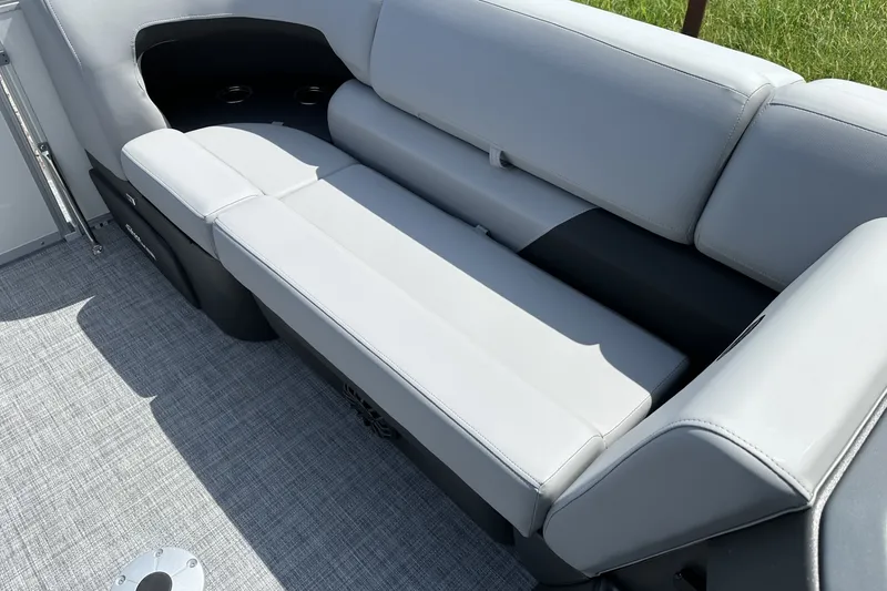 Slide: The Image of 2027 Sun Tracker Party Barge 22 RF DLX, featuring sleek gray seating and modern design. - 13