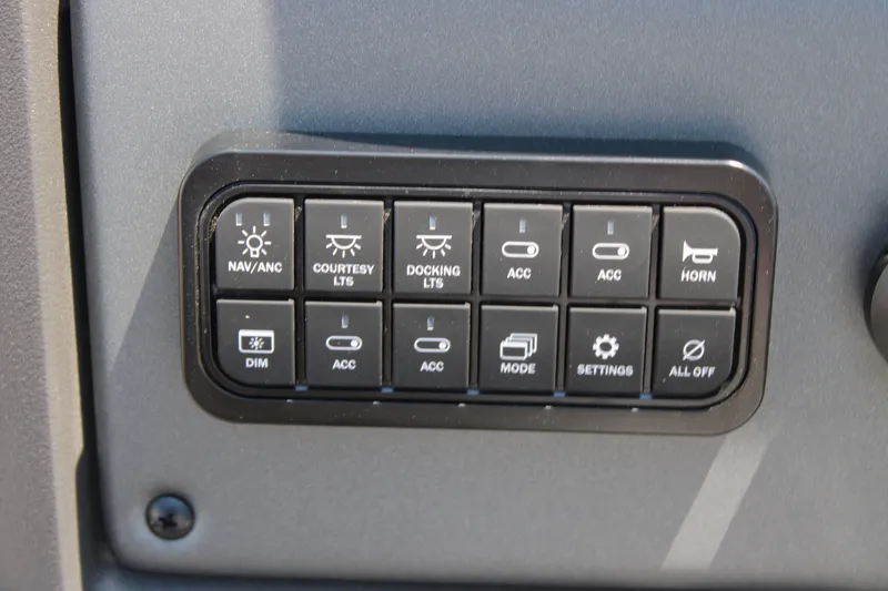 Slide: The Image of Control panel of 2027 Sun Tracker Party Barge 22 RF DLX with various switches. - 22