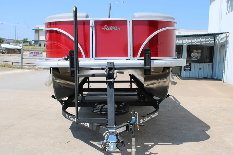 Slide: The Image of 2027 Sun Tracker Party Barge 22 RF DLX pontoon boat on trailer, front view. - 13