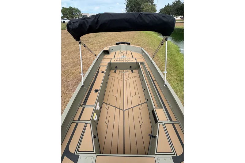 Slide: The Image of 2027 Tracker Grizzly 1756 T Marsh boat with sleek deck design and canopy. - 19