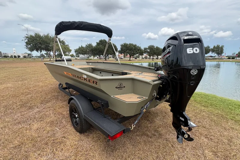 Slide: The Image of 2027 Tracker Grizzly 1756 T Marsh boat with Mercury 60 engine by a lake. - 82