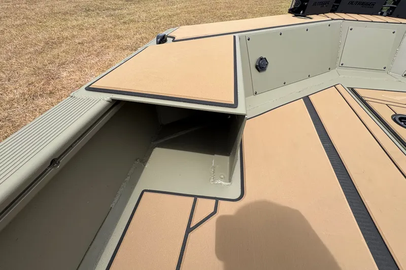 Slide: The Image of 2027 Tracker Grizzly 1756 T Marsh boat interior with open storage compartment. - 13