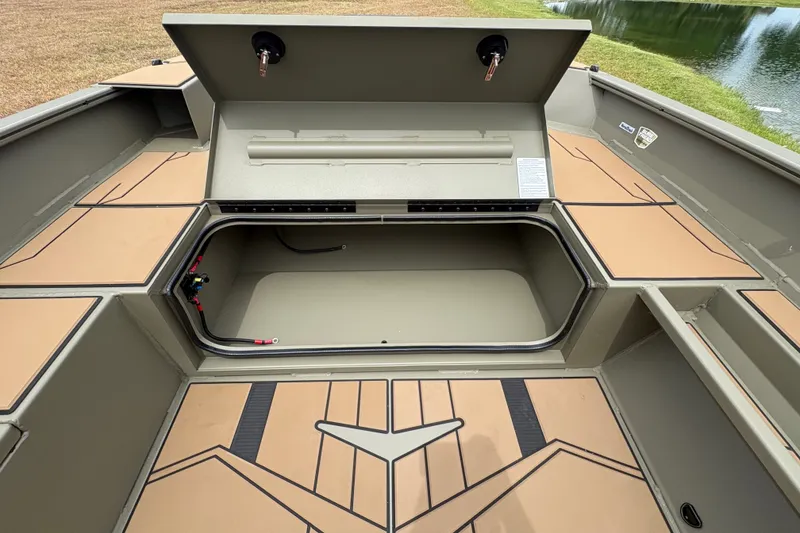 Slide: The Image of 2027 Tracker Grizzly 1756 T Marsh boat storage compartment open, showcasing interior space. - 16