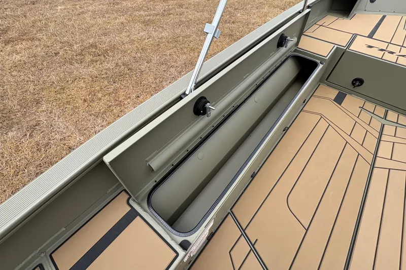 Slide: The Image of 2027 Tracker Grizzly 1756 T Marsh boat interior with open storage compartment. - 18