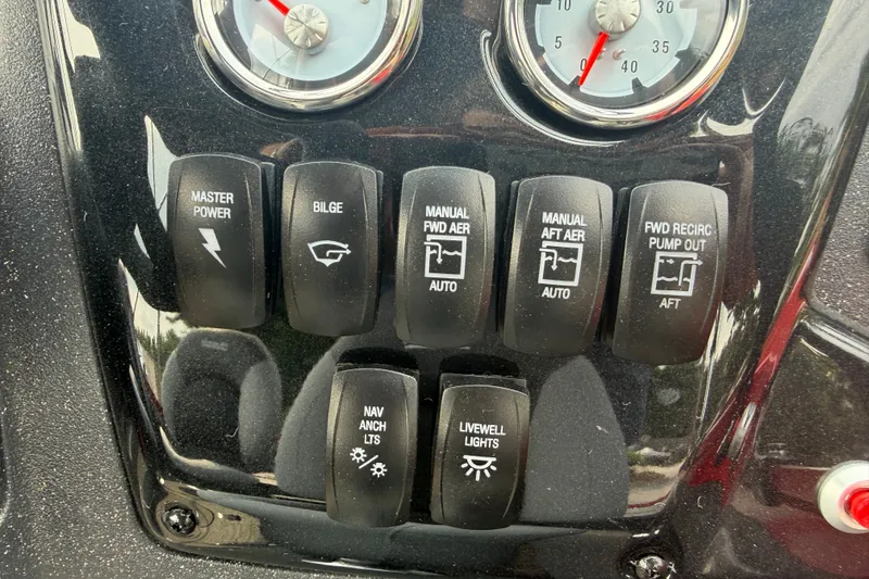 Slide: The Image of Control panel of 2027 Tracker Targa V-19 Combo boat with various switches and gauges. - 45