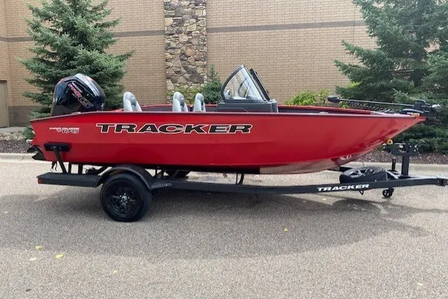 The Image of 2027 Tracker Pro Guide V-175 Combo boat, red, on trailer, parked outdoors. - 0
