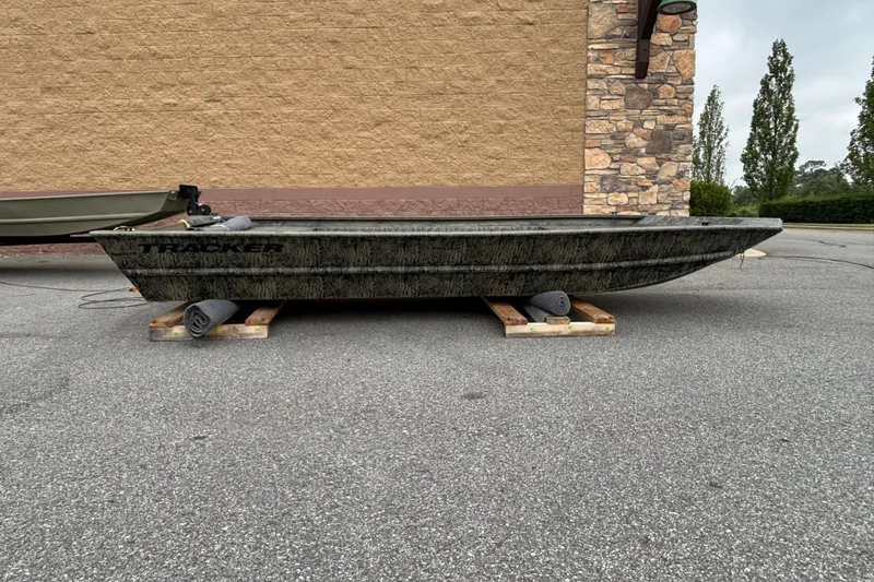 The Image of 2027 Tracker Grizzly 1754 Utility boat on pallets, parked outdoors. - 0
