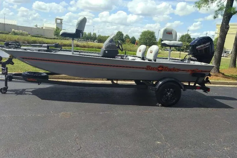 The Image of 2027 Tracker Bass Tracker Classic Limited boat on trailer, parked outdoors. - 0